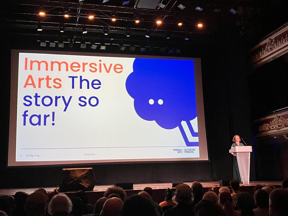a woman presenting to an audience of people