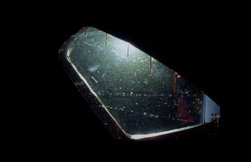 a window covered by small glittering pieces of dust shortly after take-off