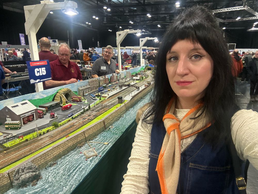 Me standing beside a model train set 