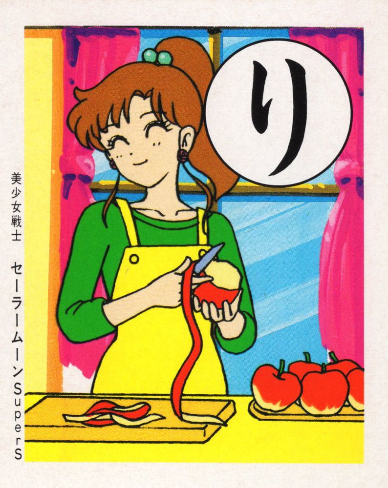 A smiling Makoto peeling apples in her kitchen