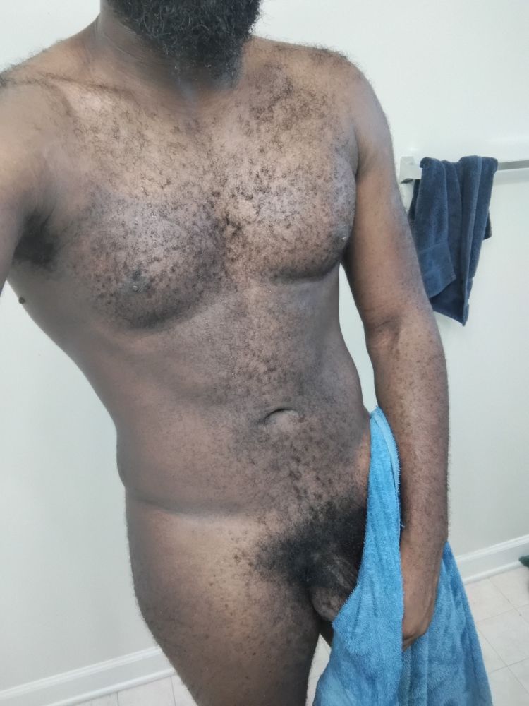 Fresh out of the shower, still wet, towel covering just enough though my bush and dick root are visible 