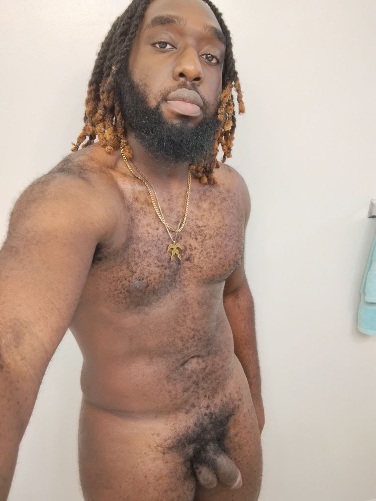 A nude selfie featuring my flaccid dick, I am wearing nothing but 2 golden necklaces