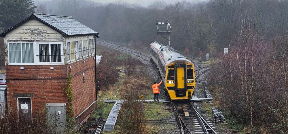 Tondu signal box with the Signaller receiving a token from the driver of a train