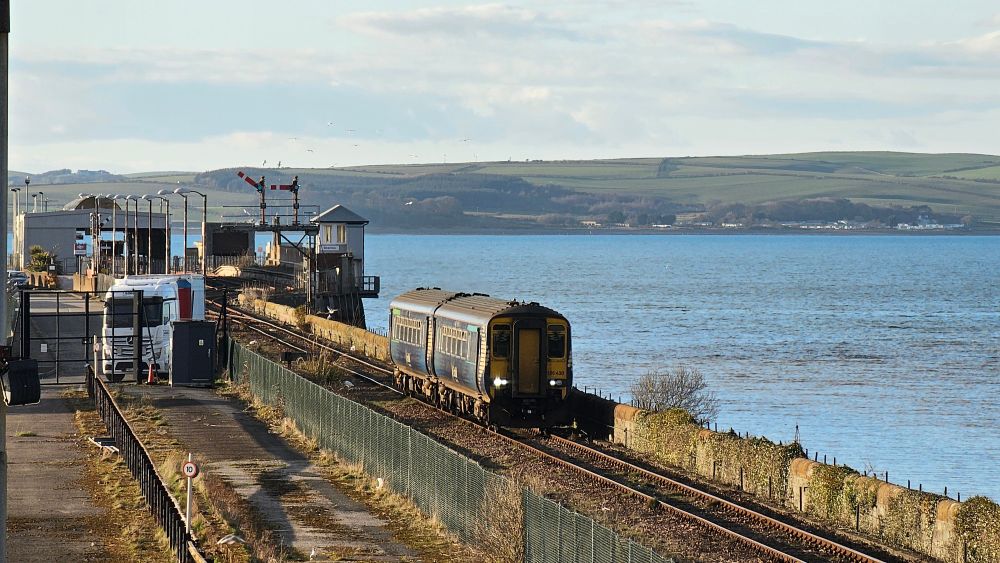 A ScotRail Class 156 train departs Stranraer station for Ayr
