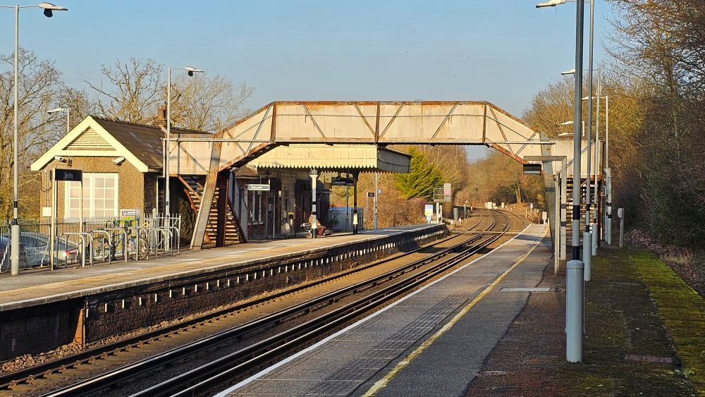 A general view of Bentley station showing both platforms, the footbridge and station canopy.