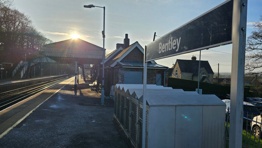 Bentley station sign with the sun setting above the canopy