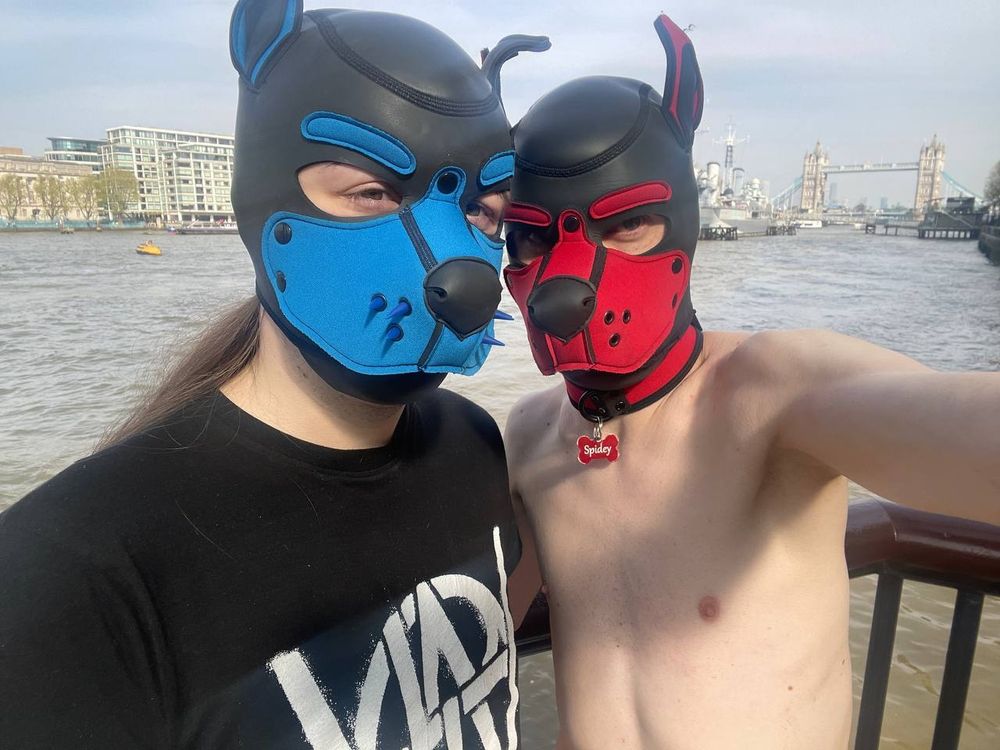 Spidey and Asper taking a photo in front of Tower Bridge with the river thames behind them.