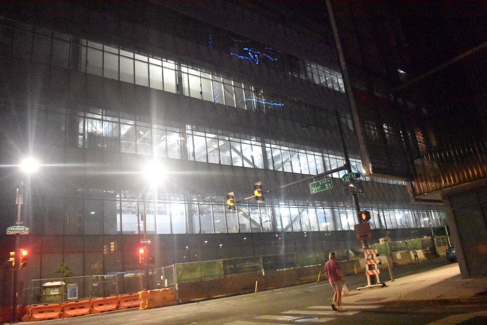 3100 chestnut street. Building under construction with outer shell on and lit up inside.