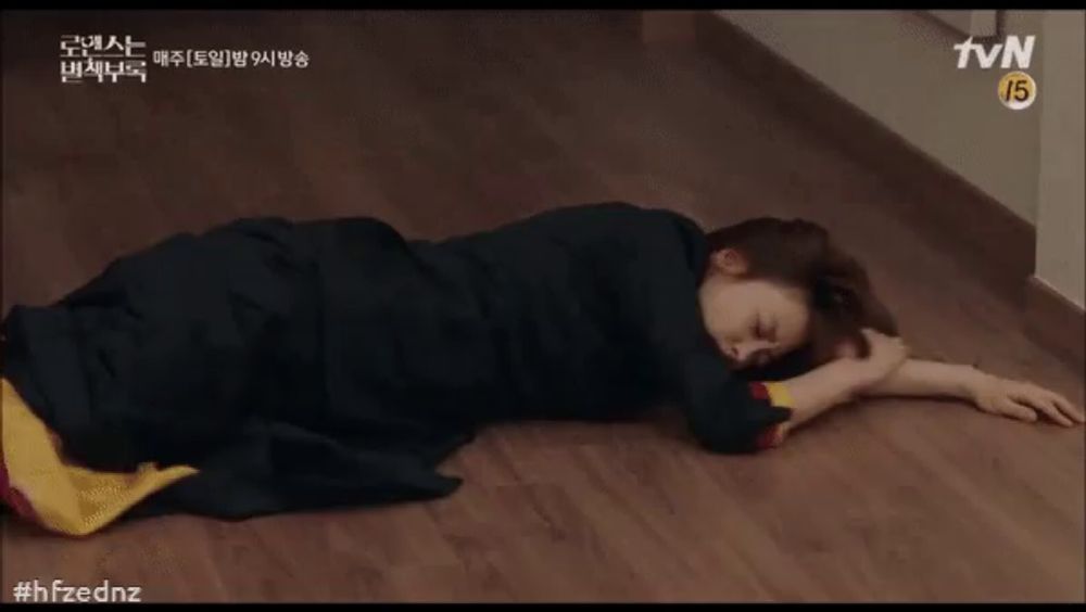 a woman in a black dress is laying on the floor in a tvn advertisement