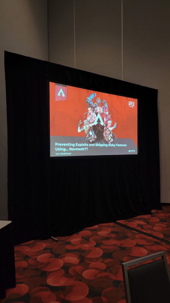 Picture of a projected slide reading "preventing exploits and shipping risky features using... Navmesh???" 