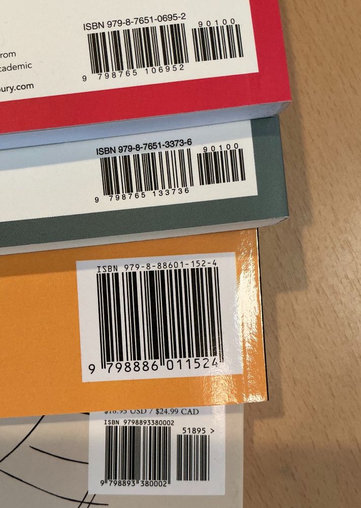 The bar codes of 4 books, with ISBNs all starting with 979-.
