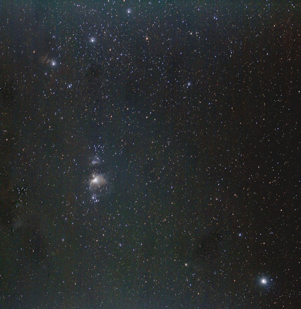 The three stars representing the belt of Orion at upper left corner. The Flame nebula next to Alnitak on the belt at upper right corner. Slight hint of the Horsehead nebula below them. Great Orion nebula at left of centre. The bright star Rigel at bottom right corner.