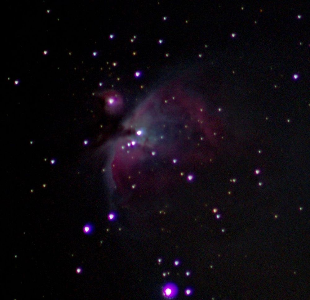 The Orion nebula at centre with bits of other nebulosity and star dots. 