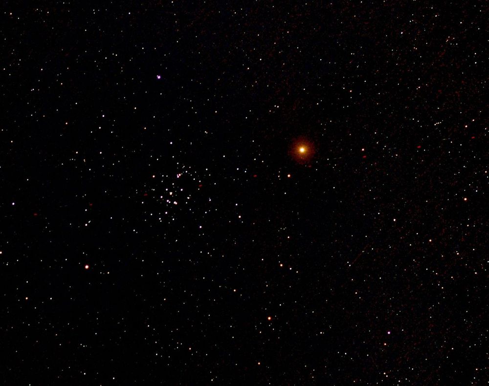 Red planet mars right of centre. The Beehive cluster of stars left of centre. Many other star dots. 