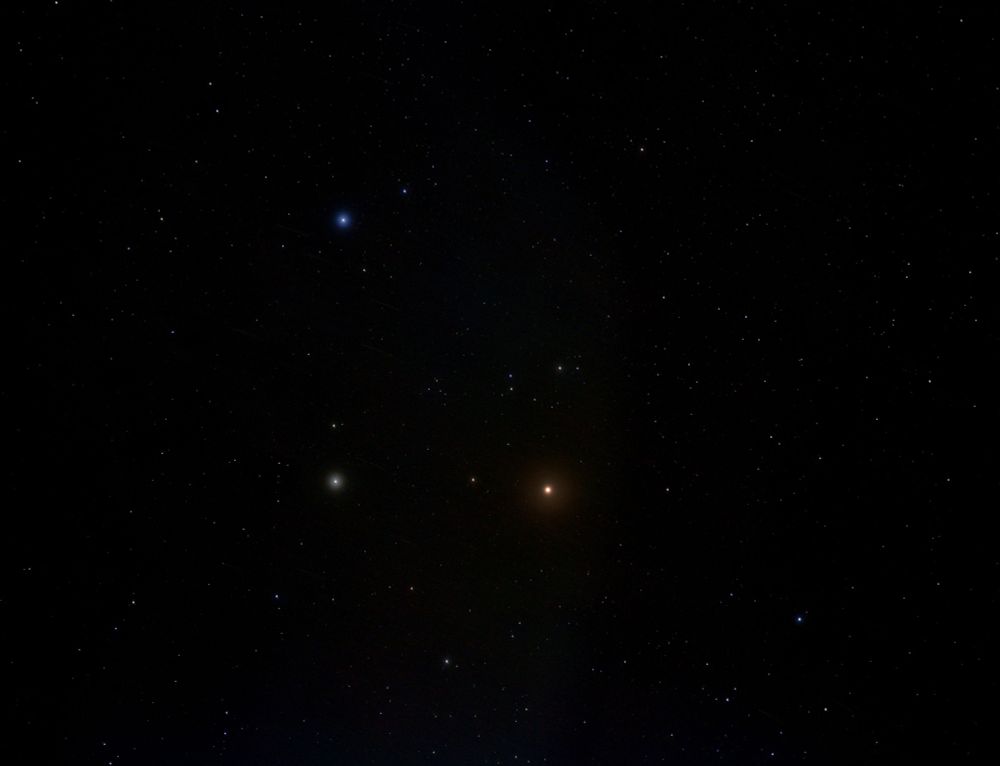 Bright planet Mars below centre. Star Pollux to its left and blue star Castor above. Numerous other star dots. 