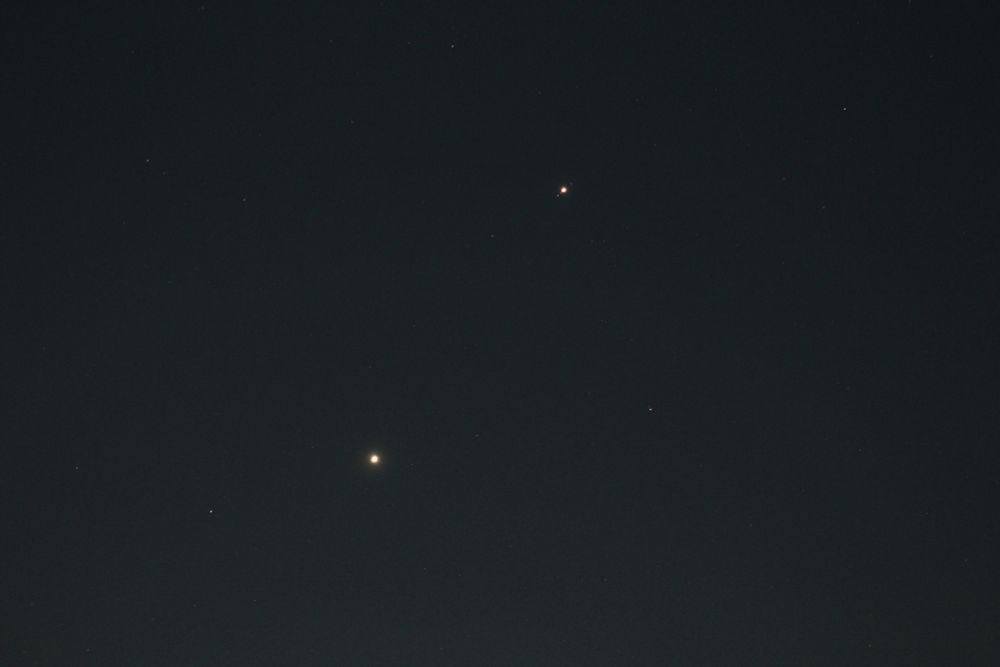 Planet Venus dot below centre. Planet Jupiter dot above centre. 