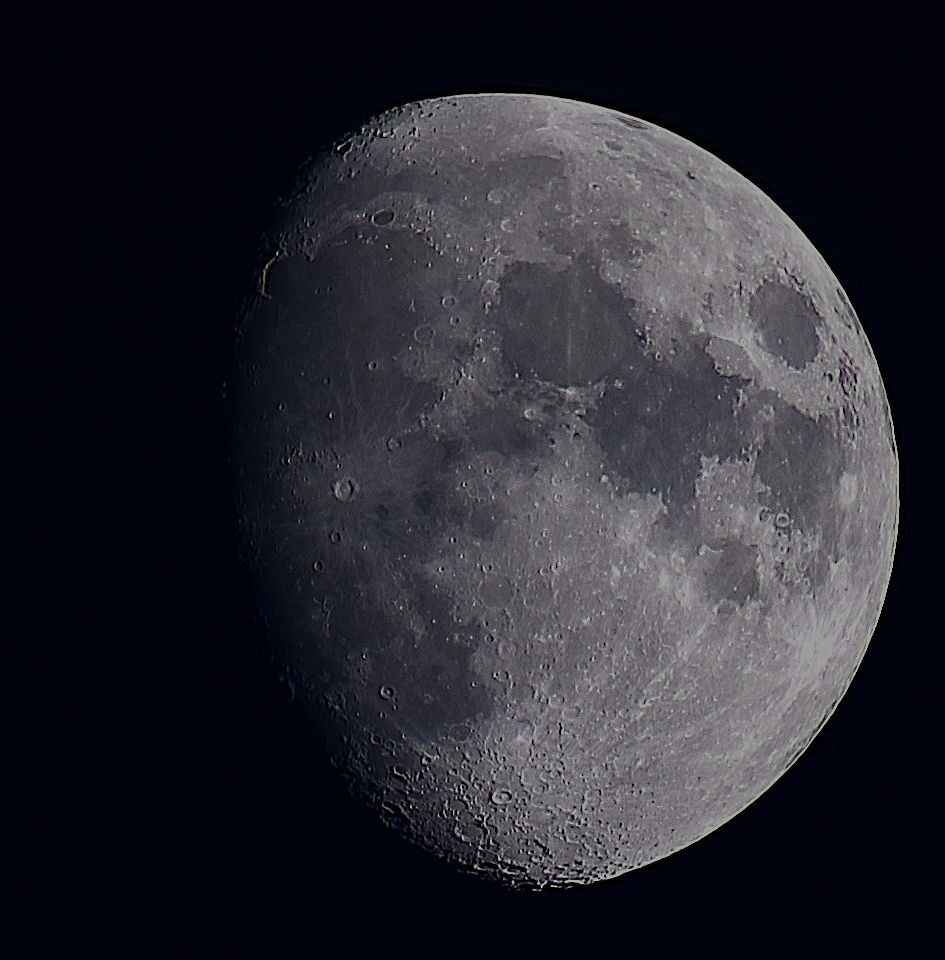The Moon at waxing gibbous phase on a dark background. 