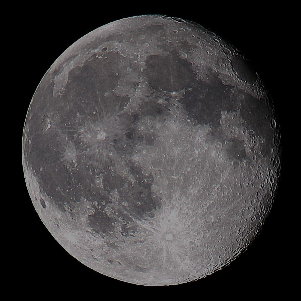 The Moon at waning gibbous phase on a dark background. 