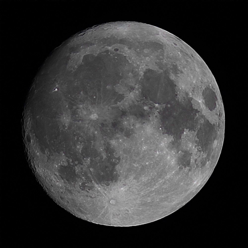 The Moon at waxing gibbous phase on a dark background. 