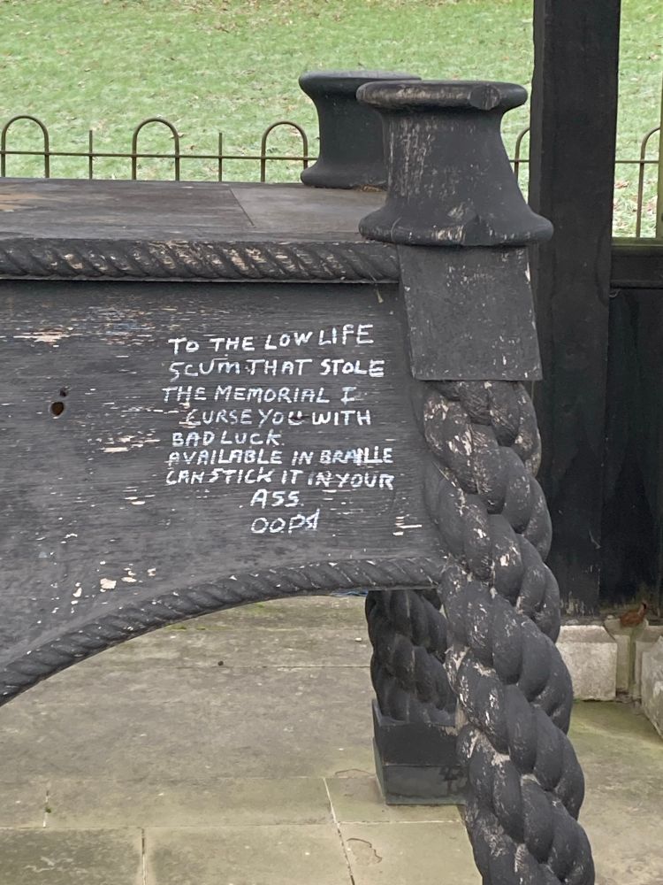 Rude graffito reading “to the low life / scum that stole / the memorial I / curse you with / bad luck / available in braille / can stick it in your / a*# / oopd 