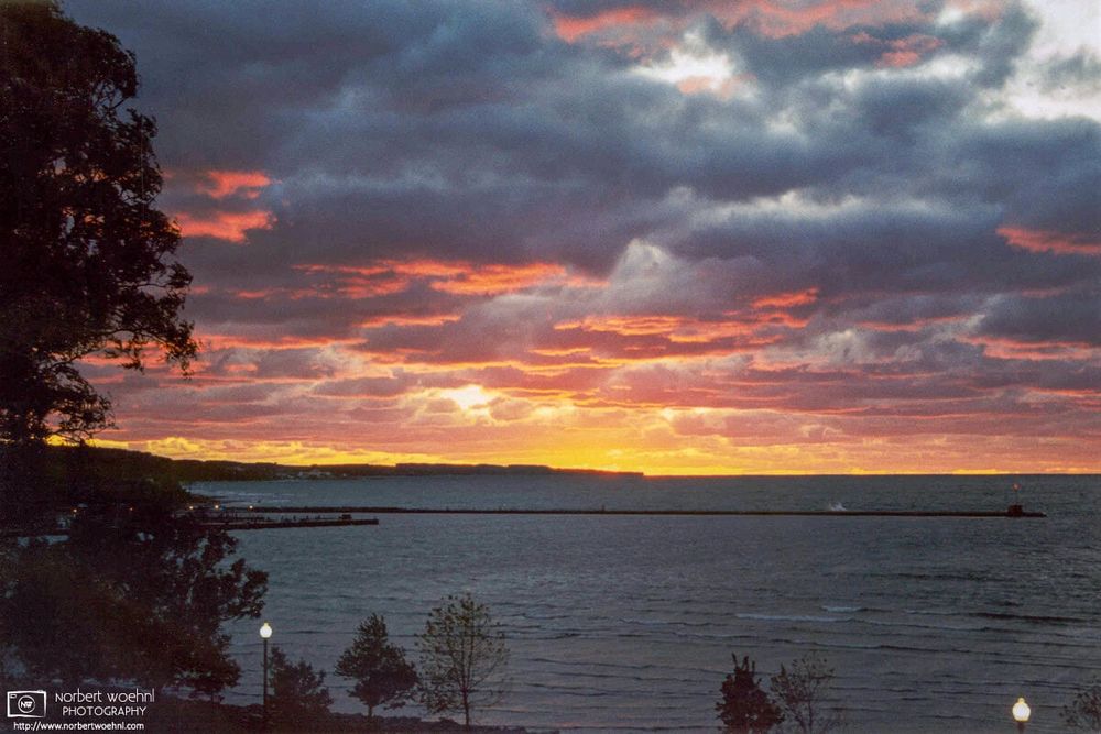 Sunset view of Little Traverse Bay from the aptly-named Sunset Park in Petoskey, one of the northernmost cities on the Lower Peninsula of Michigan.