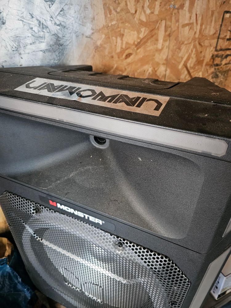 Speaker with sticker of artist Unwoman 