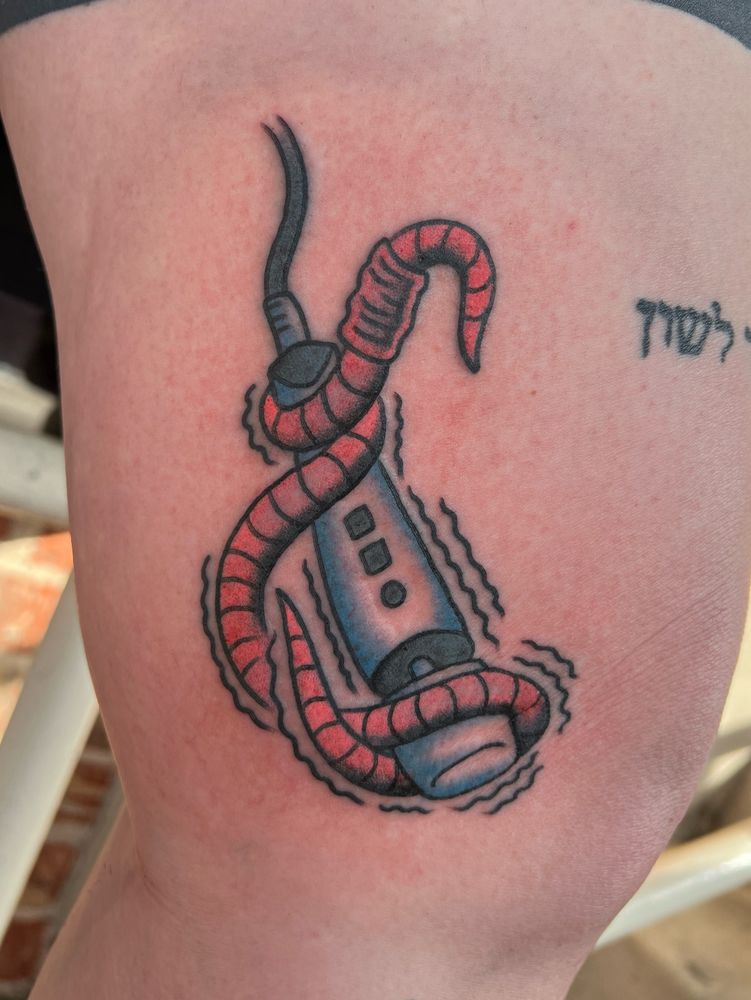 Photo of a tattoo of a worm wrapped around a hitachi wand
