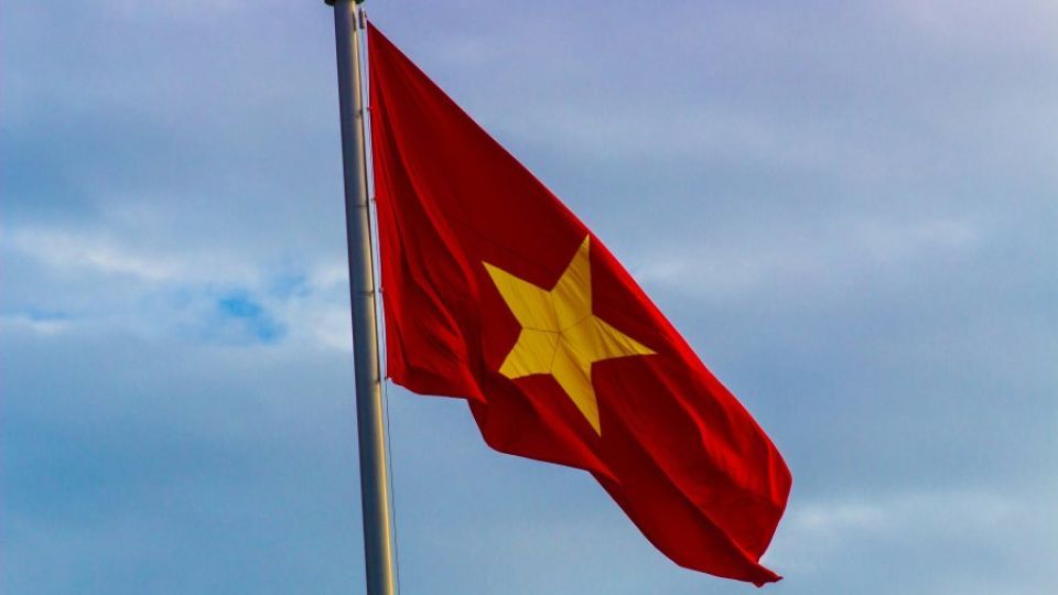 The flag of Vietnam flying from a pole