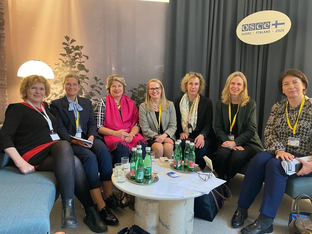 Mary Lawlor, UN Special Rapporteur on the situation of human rights defenders, sits with EU ambassadors for human rights — Amb. Ms. Irina Schoulgin-Nyoni (Sweden), Amb. Ms. Katrin Kivi (Estonia), Amb. Ms. Katja Pehrman (Finland), Amb. Ms. Gesa Bräutigam (Germany), Amb. Ms. Anne Goedert (Luxembourg) and Amb. Ms. Jurgita Germanavičienė (Lithuania)  — during the OSCE Supplementary Human Dimension Meeting in Finland, 2025. The group is seated together indoors with OSCE signage in the background.