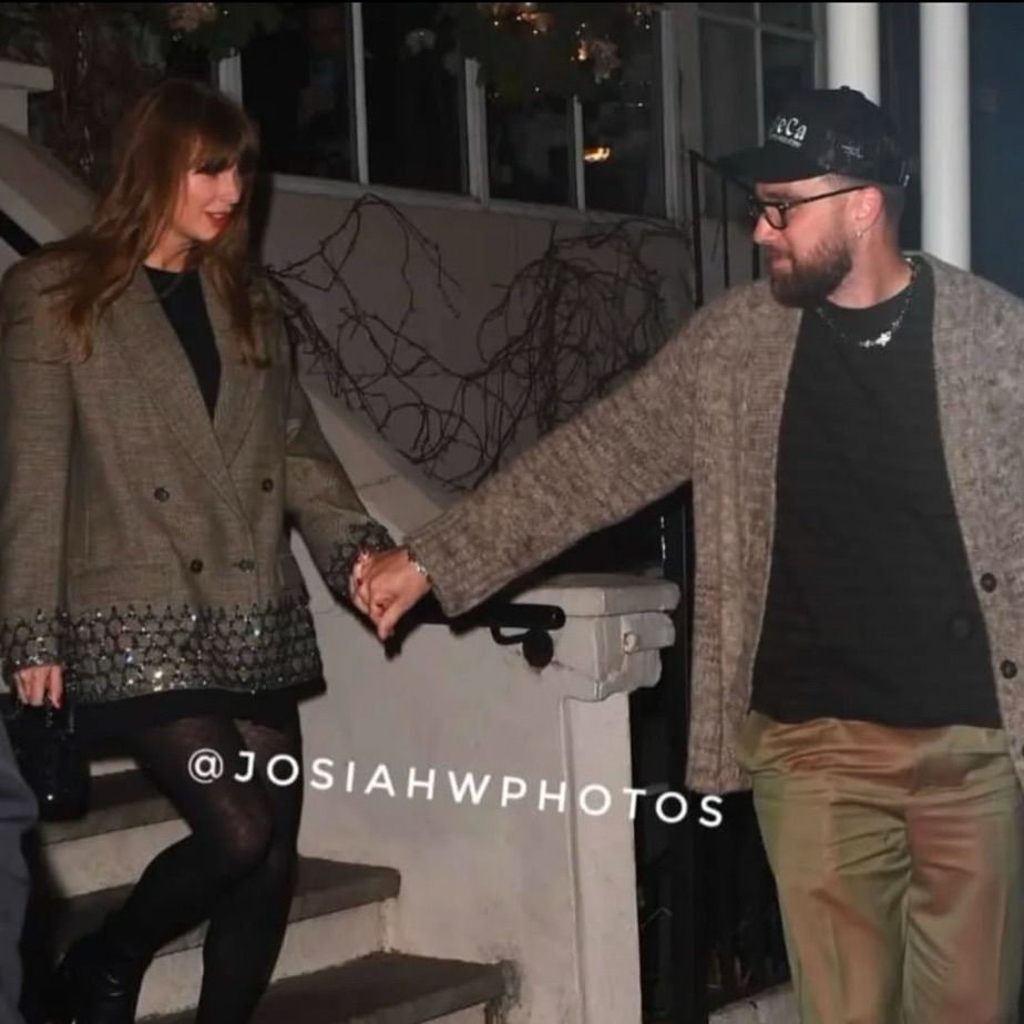 taylor and travis walking down the stairs
