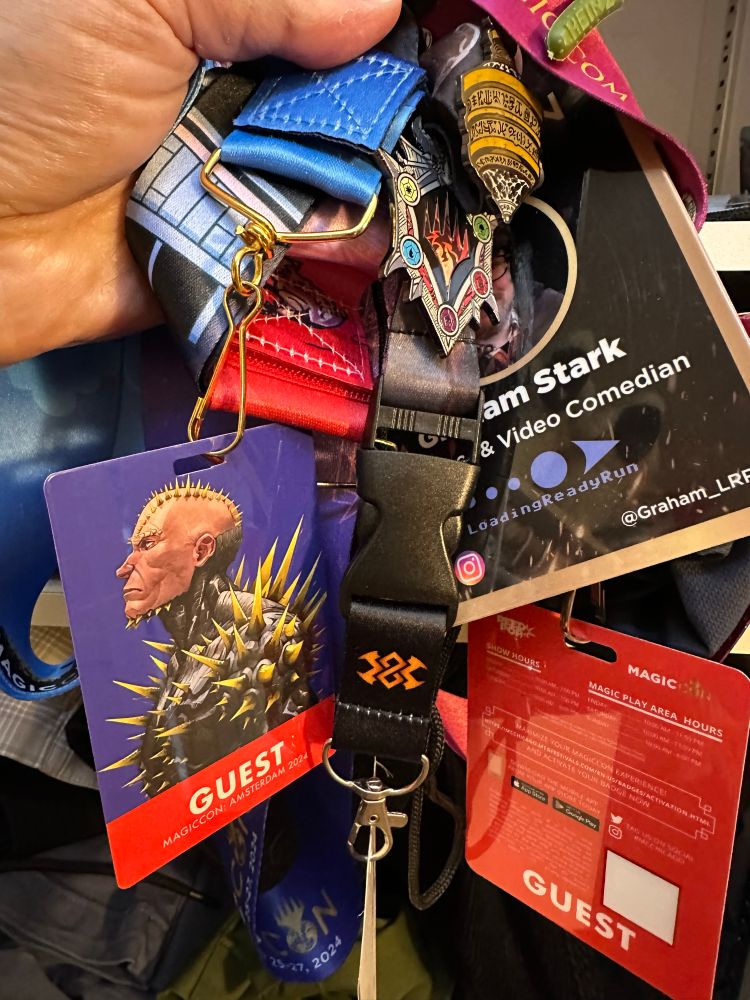 An absolute mess of MagicCon lanyards and guest badges. 