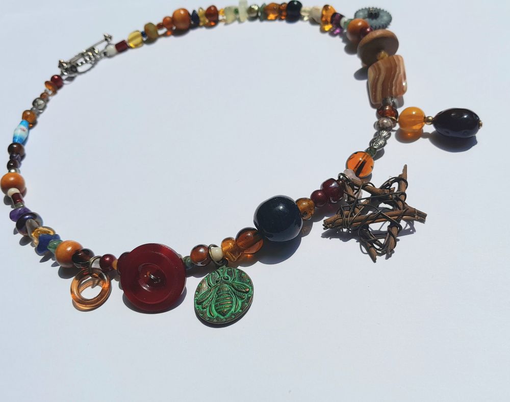 20" necklace and with vintage natural stone, pearls, glass, wood, paper and metal beads with a button, gear, and grapevine pentacle and a silver-coloured toggle clasp.