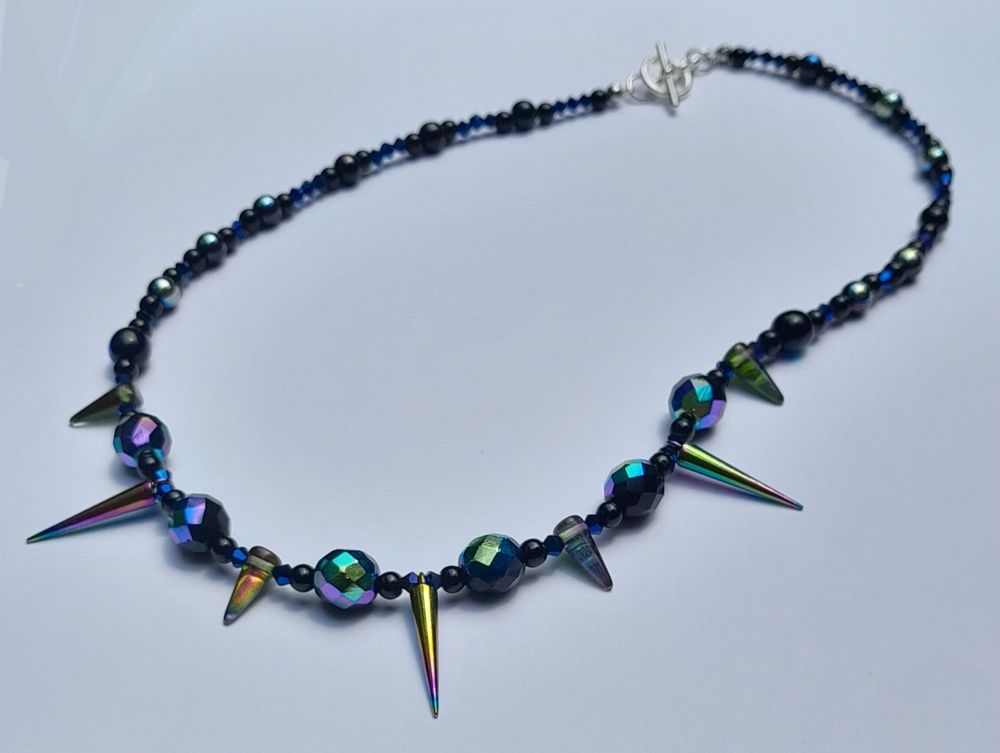 20" necklace with iridescent black glass beads, glass and metal spikes and a silver-coloured metal toggle clasp.
