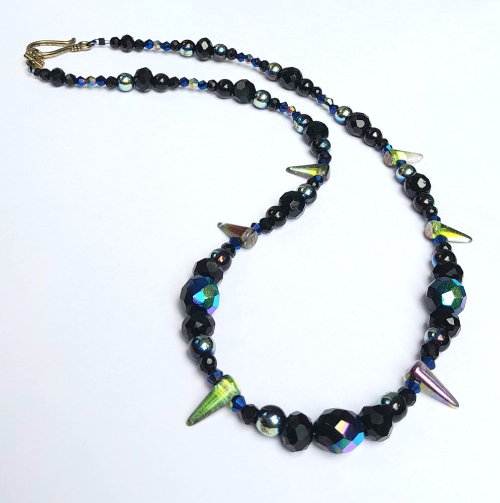 21" necklace with iridescent and black glass beads and spikes and an antique gold-coloured hook clasp.