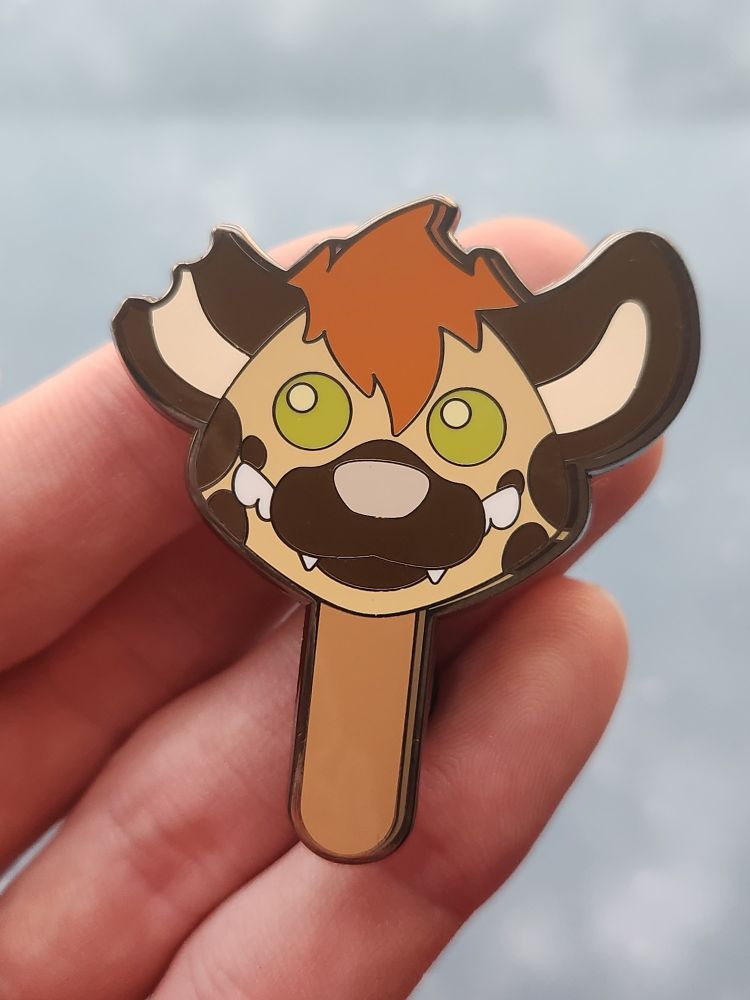 The front face of a gumball popsicle themed enamel pin with a bitten ear