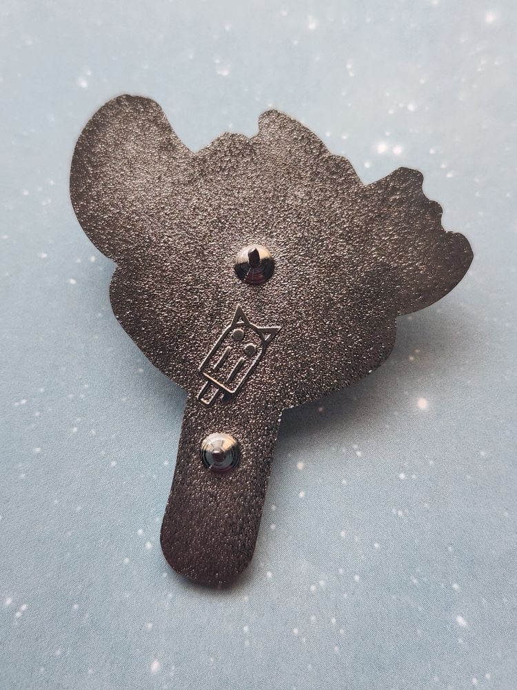 The back of a hyena themed enamel.pin showing 2 clutch locations for a secure not rotating hold