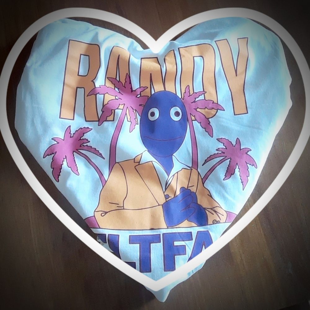White t-shirt with a stamp of Randy's First Banana promo picture. Sleeves and waste are tucked to form a heart shape with another heart form added digitally over the shirt.