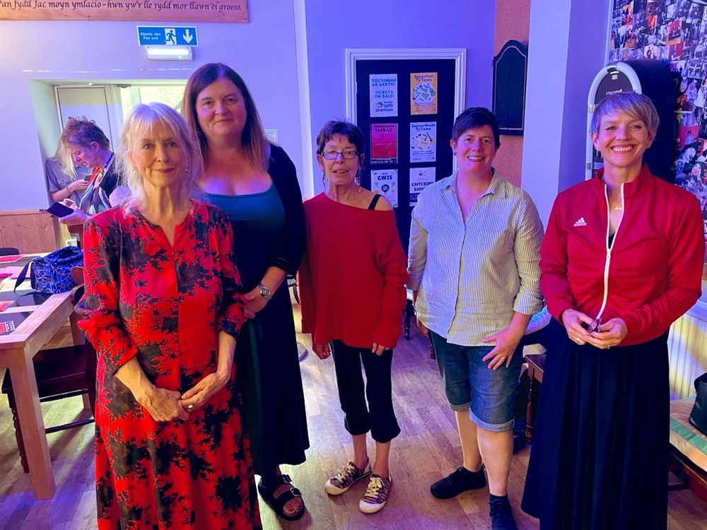 Sharon Morgan, Delyth Wyn and Maria Pride standing with Sioned Williams MS and Kate from Welsh Women’s Aid.