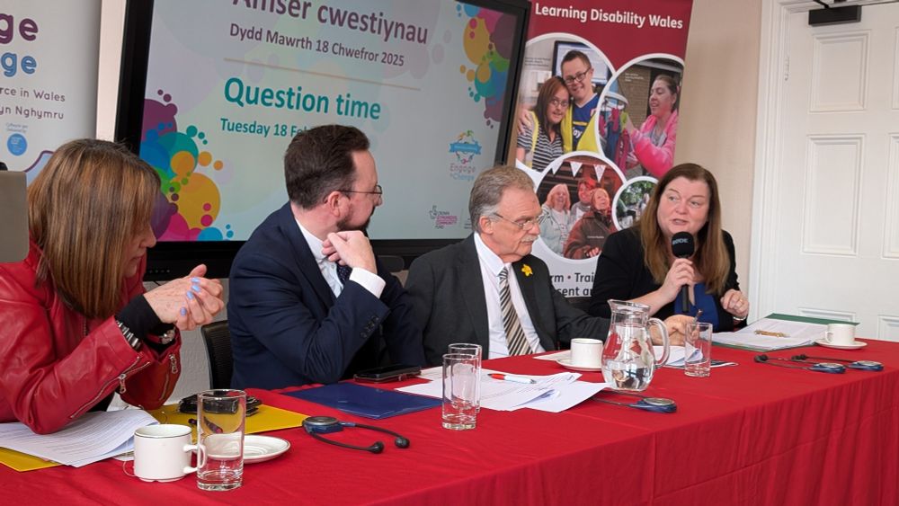 Sioned Williams MS sits at a table alongside Mark Isherwood MS, Hefin David MS and Jane Dodds MS. They are all on one side of the table, as they are on a panel, answering questions from the audience (unseen).