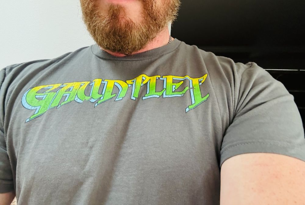 Close up of my t-shirt, a gray T with the green 80's Gauntlet video game logotype.