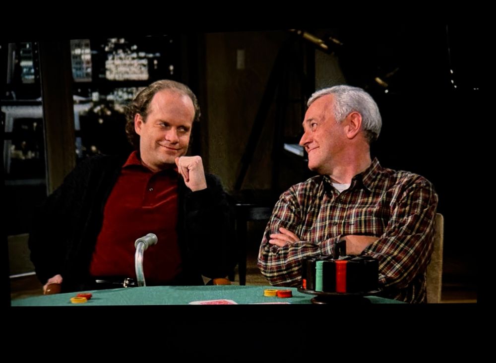 Frasier and Martin Crane smiling at each other 
