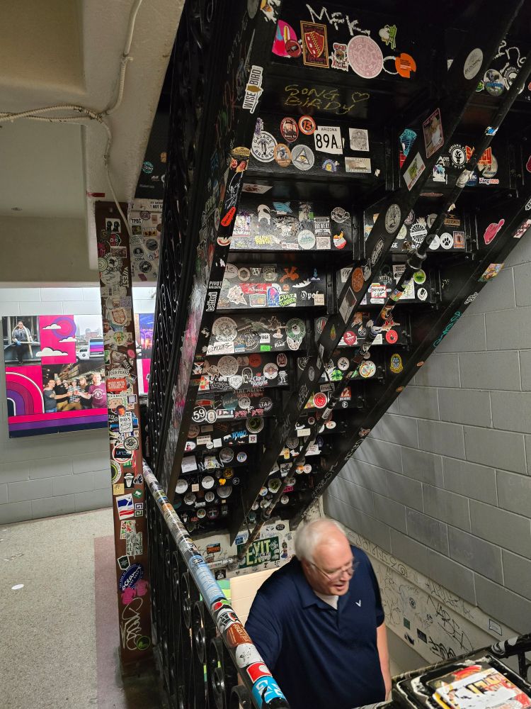Underside of stairway covered in stickers