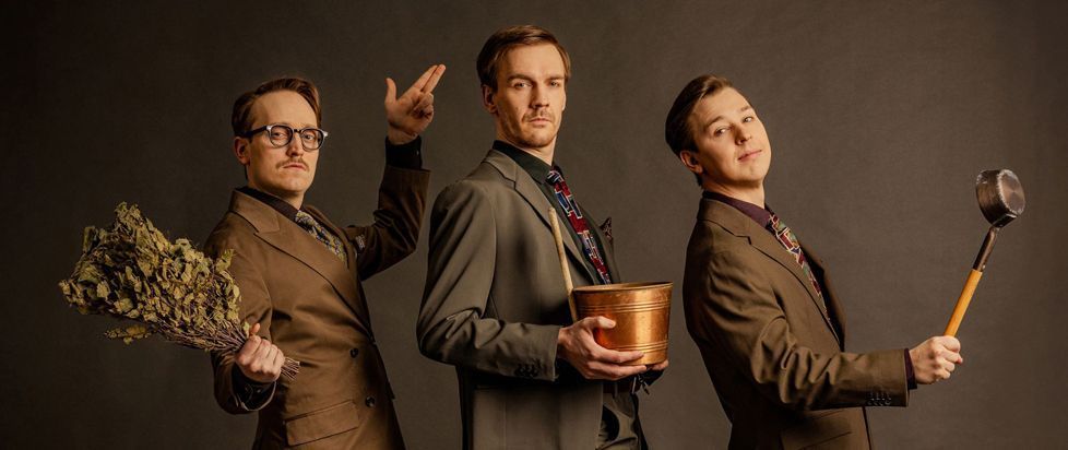 The three members of KAJ pose with a bouquet of herbs, a bucket, and a ladle.