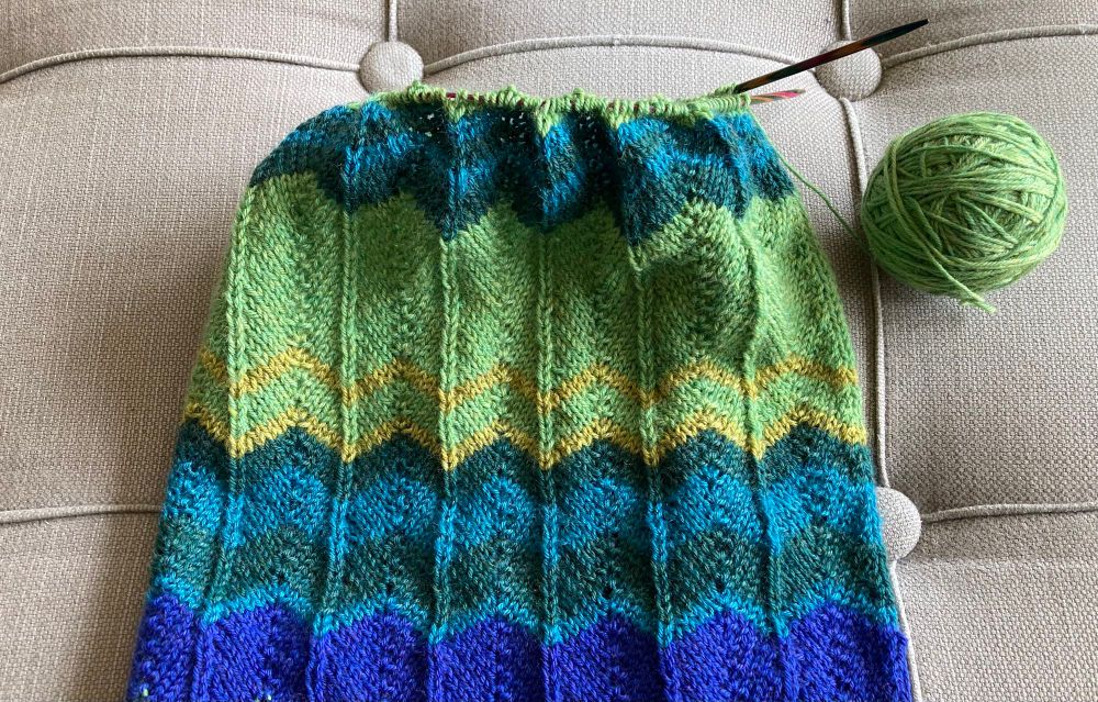 Section of a striped scarf with colours denoting daily temperature highs