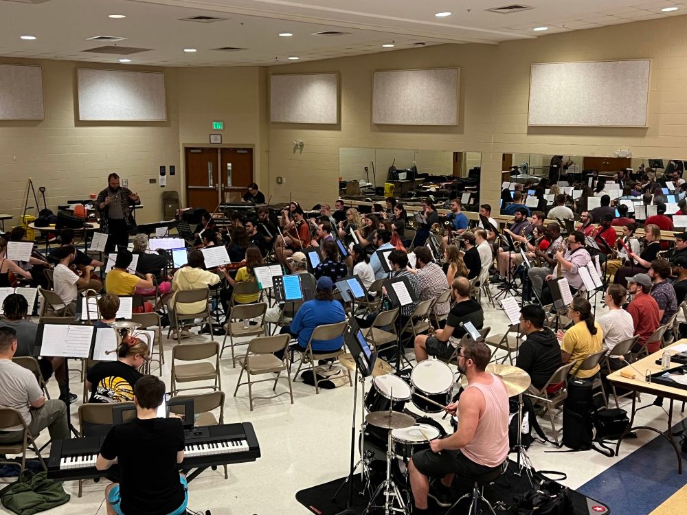 the orchestra and choir rehearsing, as seen from above