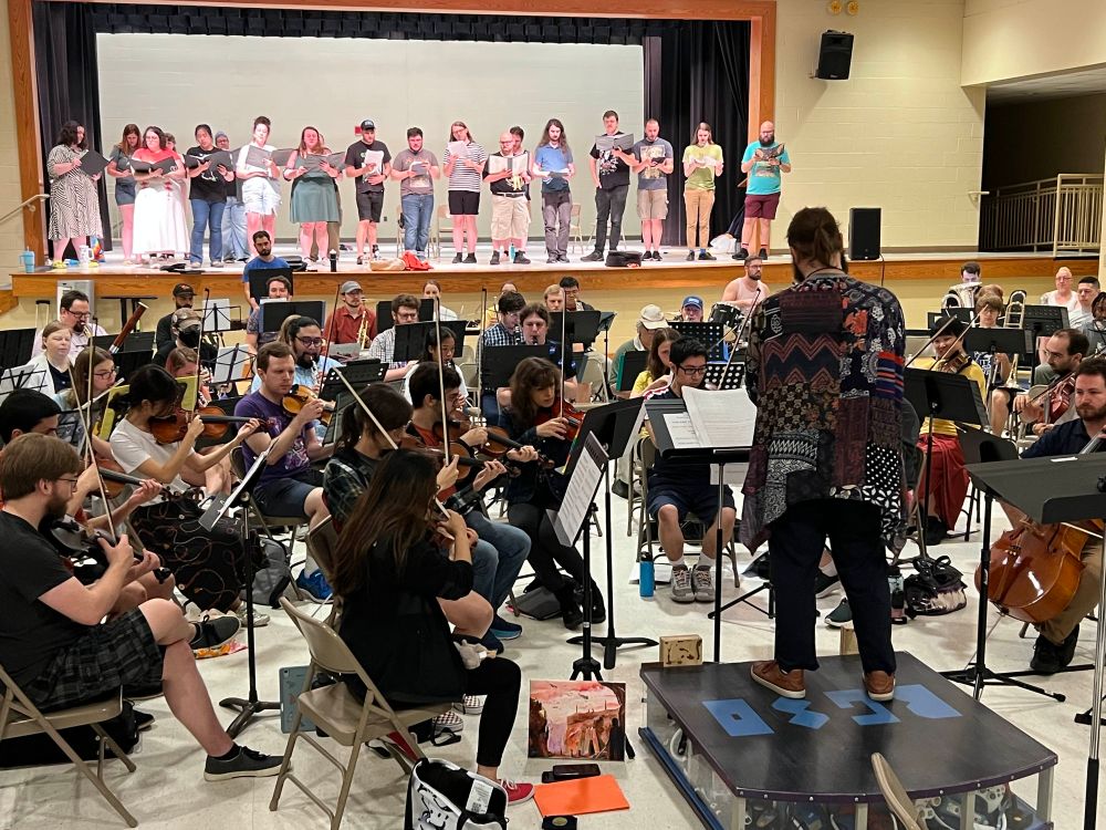 the orchestra and choir rehearsing, as seen from an audience perspective