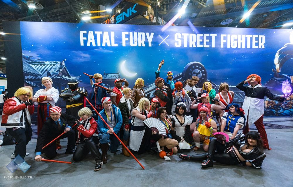 A huge group of Fatal Fury and SNK cosplayers posing for a photo.