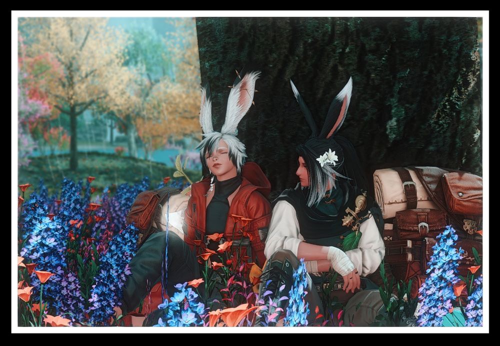 Ravnur and Thesa are sitting together at the base of a tree when it's raining in Kozama'Uka. Thesa has her eyes closed, taking in the scents and atmosphere while Rav looks at her, arms folded and one knee up. Their backpacks are next to them.