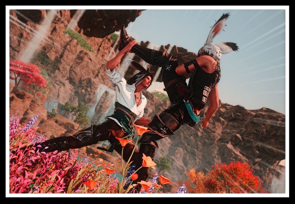 Sparring photo of Thesa and Ravnur at sunset with the falls in the background. Thesa is doing a high kick, which Rav has blocked with one hand.