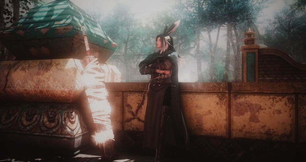 A Viera man with white-tipped black hair leans against a stone half-wall, arms crossed. His clothes are in browns and deep greens with a cape. He's looking off to the side. His greatsword, which is covered in wrappings and glowing flowers, leans against a brown-and-green stone pillar. The whole picture is slightly hazy as if dream-like.